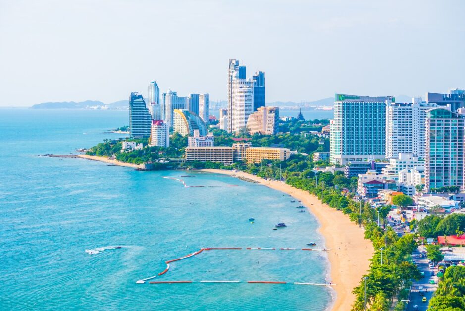 Travelers relaxing on the peaceful shoreline with clear blue skies, representing must-visit beaches in a Cam Ranh travel guide.