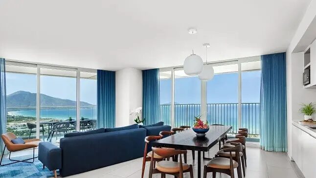 Luxury beachfront resort with palm trees and ocean views, featuring recommended stays in a Cam Ranh travel guide.