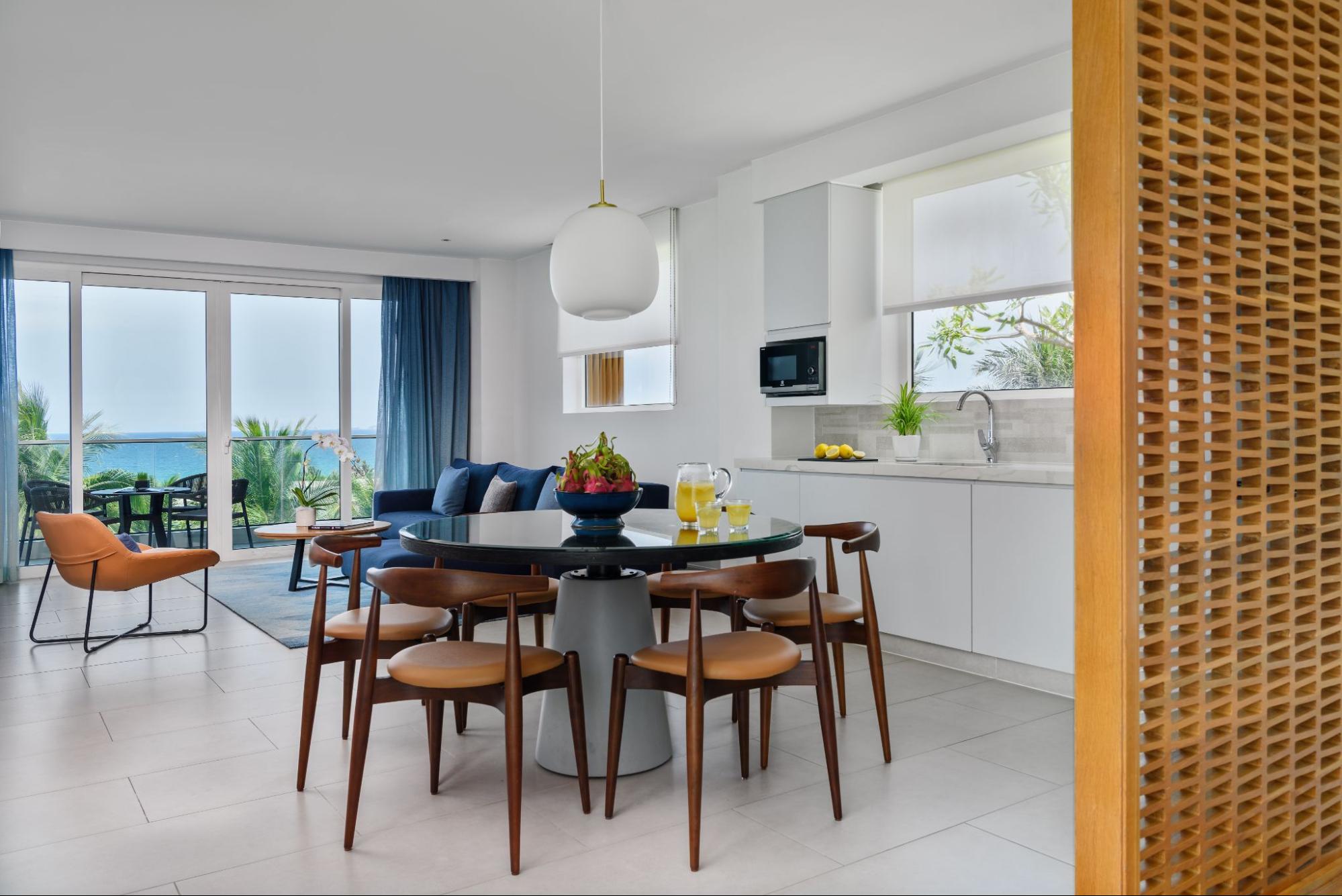 Elegant villa living room with floor-to-ceiling windows and sea views, reflecting the style of villas in Cam Ranh.