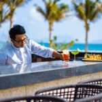 Calm crystal-clear sea with gentle waves and blue skies, highlighting the peaceful atmosphere of Cam Ranh beaches.